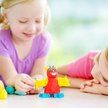 Two,Cute,Little,Sisters,Having,Fun,Together,With,Colorful,Modeling